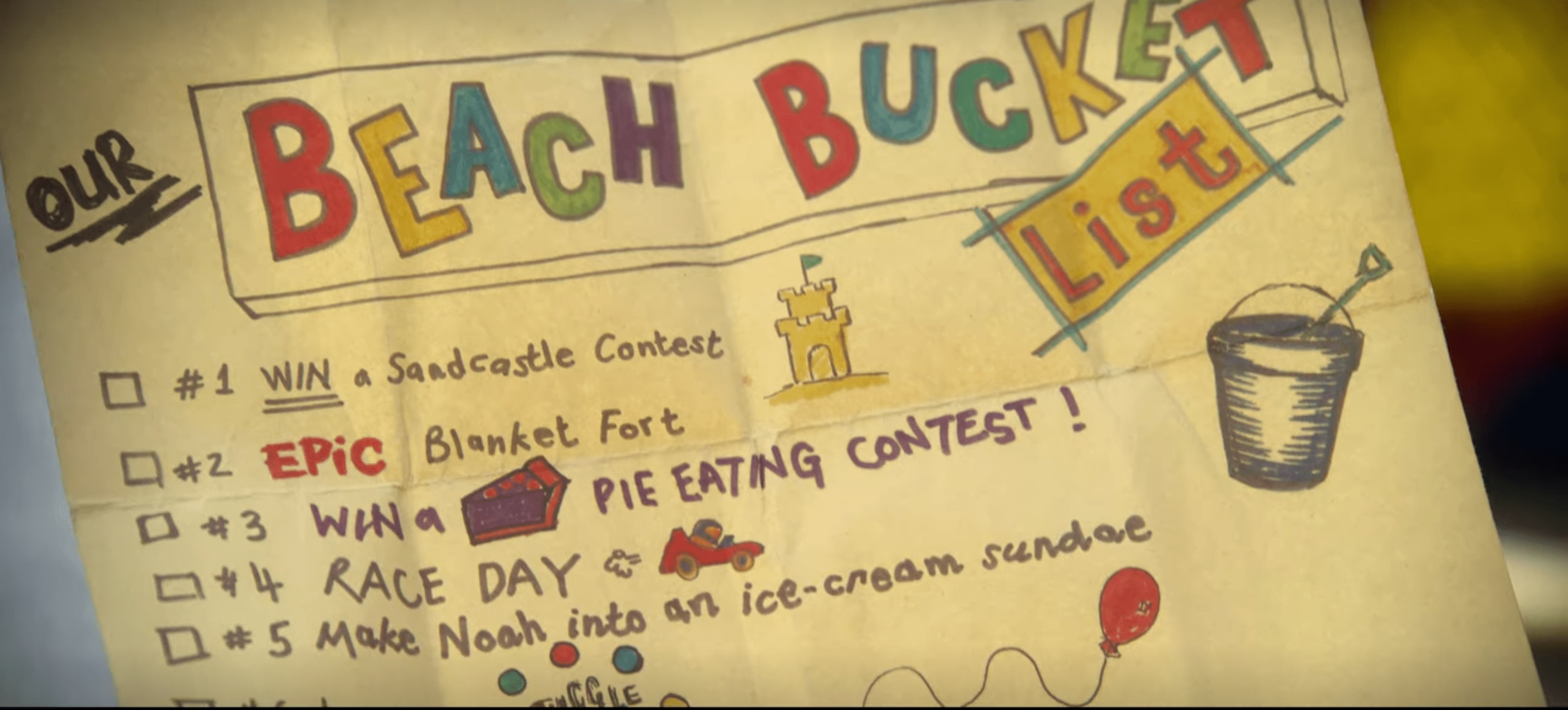 "Our Beach Bucket List" a decorated list including 1. Win a sandcastle contest, 2. Epic blanket fort, 3. Win a pie eating contest, 4. race day, 5. Make Noah into an ice cream sundae.